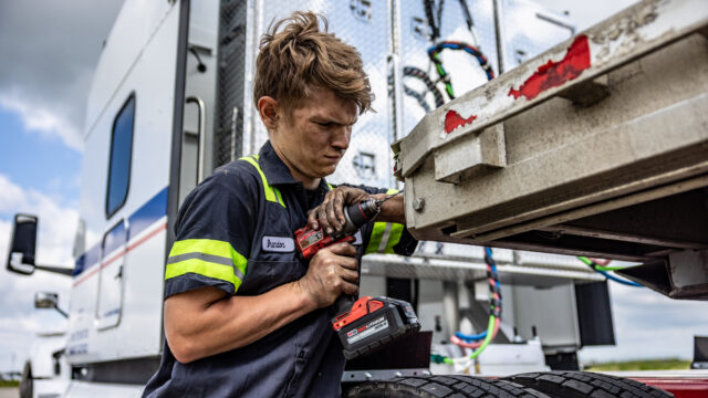 Wylie 2021 Glass Driver of the Year climbing into truck cab.